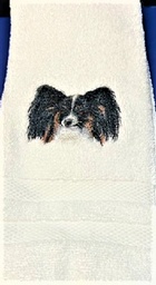 White hand towel with a beautiful stitched Tri Color papillon